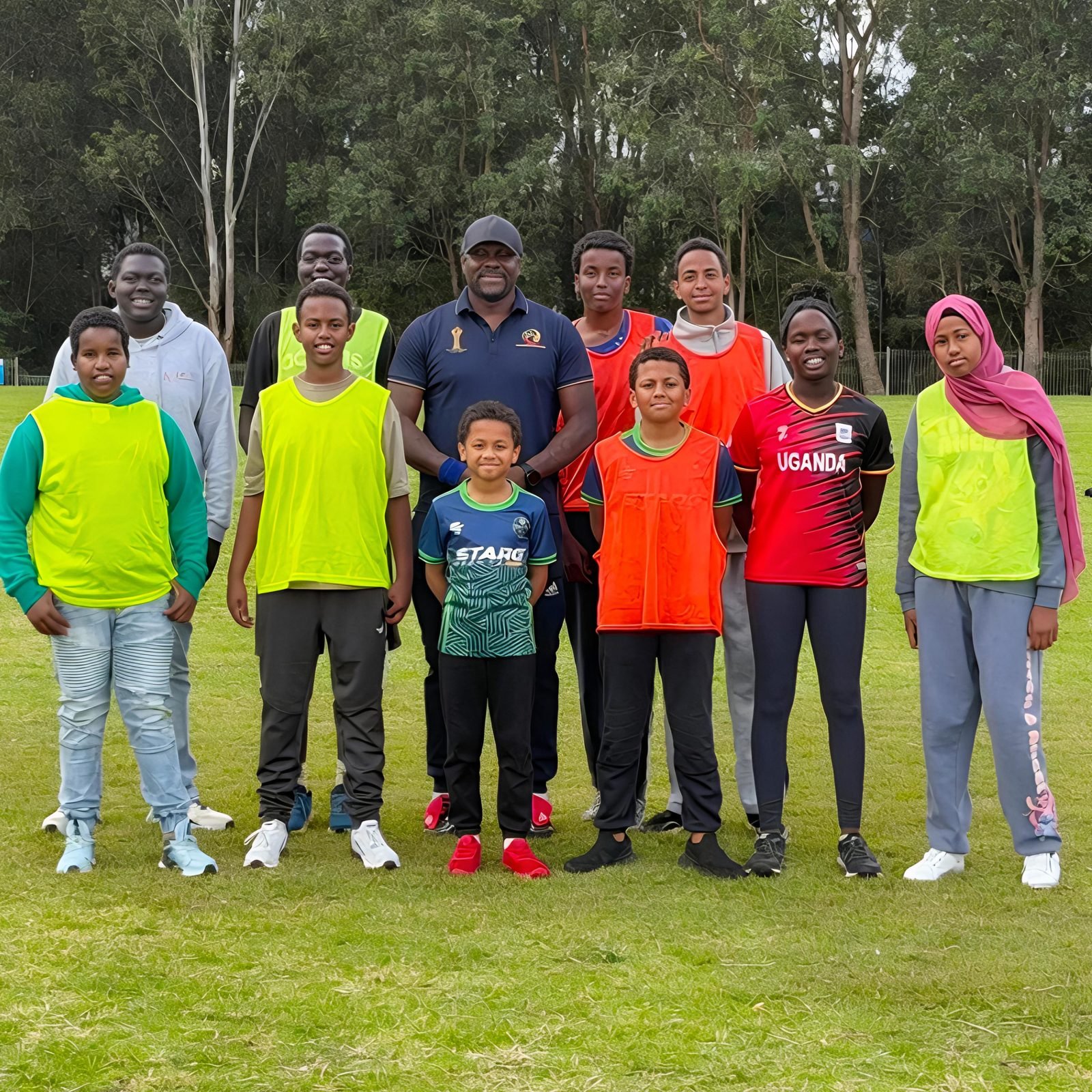 Starg Football Academy coach with a group of players on the pitch