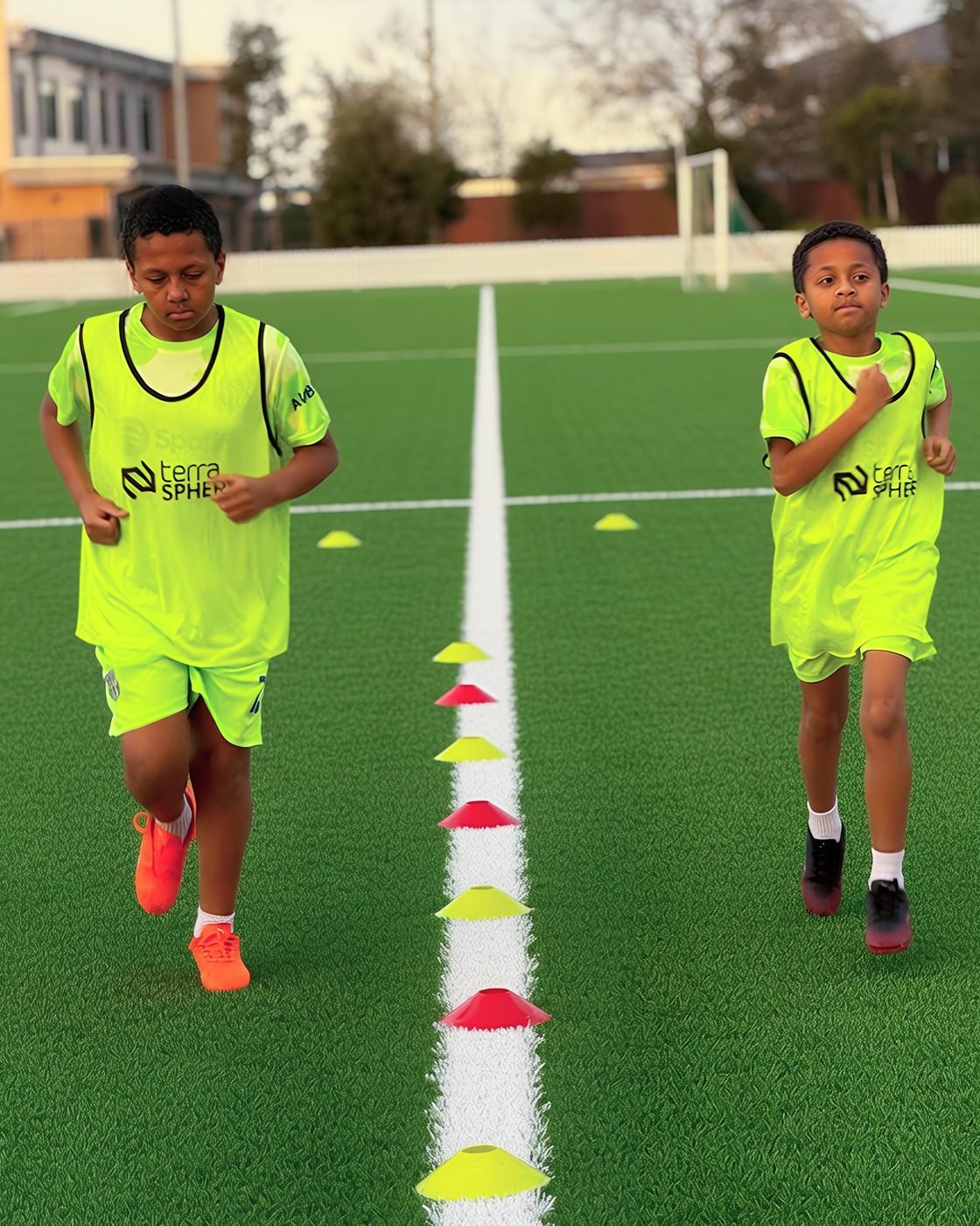 Two players running an agility drill through a line of marker cones